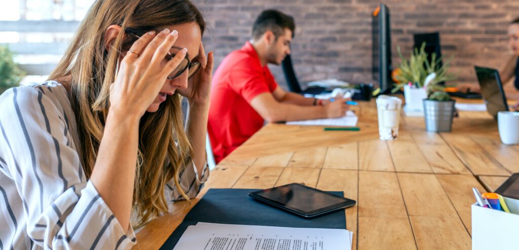 Stressed businesswoman with hands on head